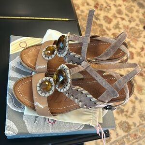 A pair of brand new sandal with shoe box and a dust bag